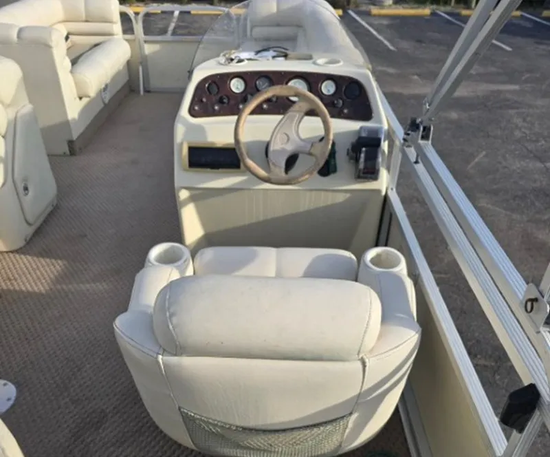 Slide: The Image of Interior of a 2001 Bennington 2050 LX pontoon boat with steering console. - 4