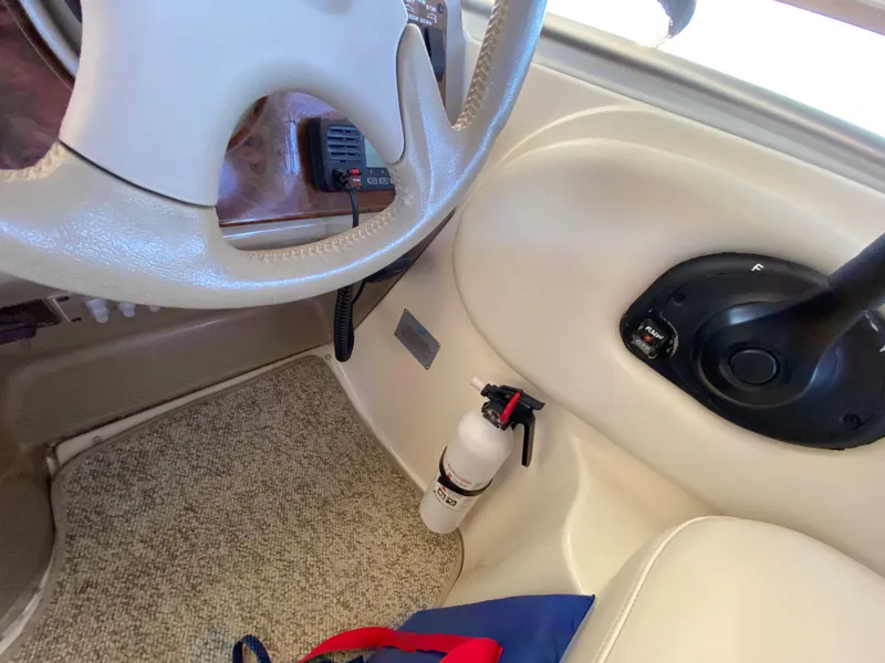 Slide: The Image of Interior of 2003 Bayliner 265 with steering wheel and fire extinguisher. - 12