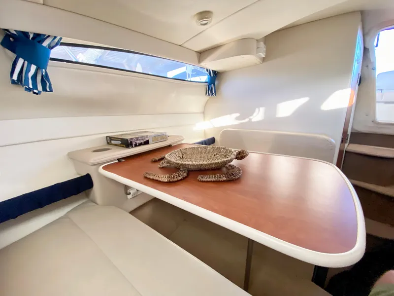 Slide: The Image of Interior of a 2003 Bayliner 265 with table and seating area. - 18