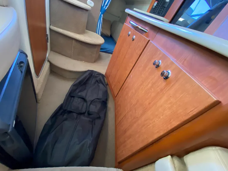Slide: The Image of Interior of a 2003 Bayliner 265 with wooden cabinets. - 21