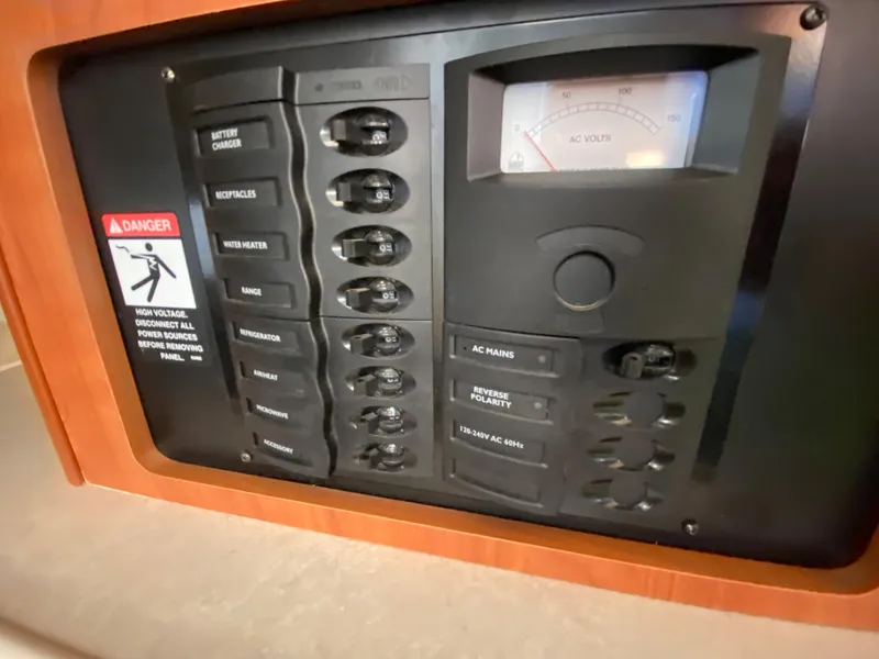 Slide: The Image of Control panel of a 2003 Bayliner 265 with warning sign. - 24