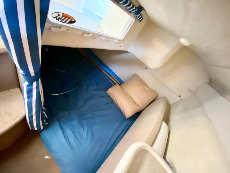 Slide: The Image of Interior of 2003 Bayliner 265 with bed and pillow. - 26