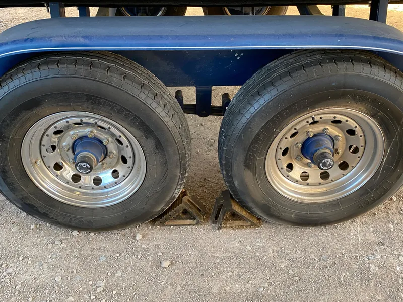 Slide: The Image of Dual trailer wheels of a 2003 Bayliner 265 boat trailer. - 31