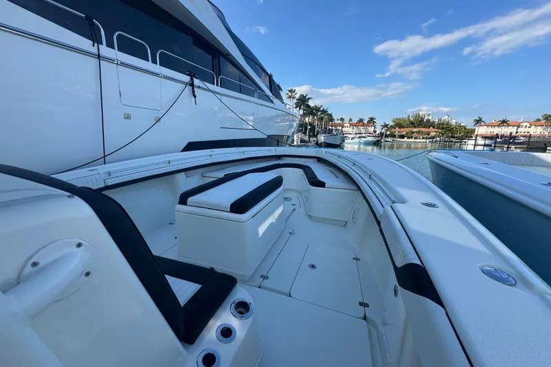 Slide: The Image of 2014 Yellowfin 39 Offshore boat docked, featuring spacious seating and sleek design. - 11