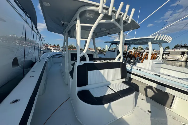 Slide: The Image of 2014 Yellowfin 39 Offshore boat with seating, docked under clear blue sky. - 17