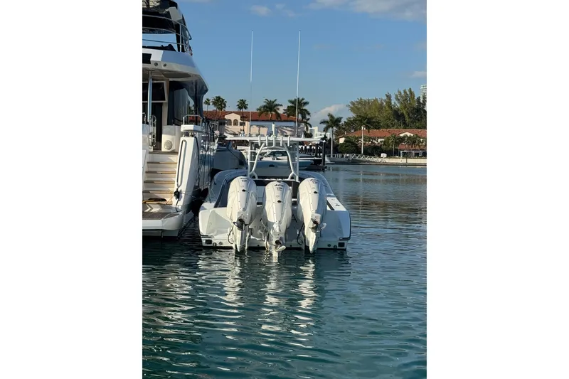 Slide: The Image of 2014 Yellowfin 39 Offshore boat docked with triple outboard engines. - 2