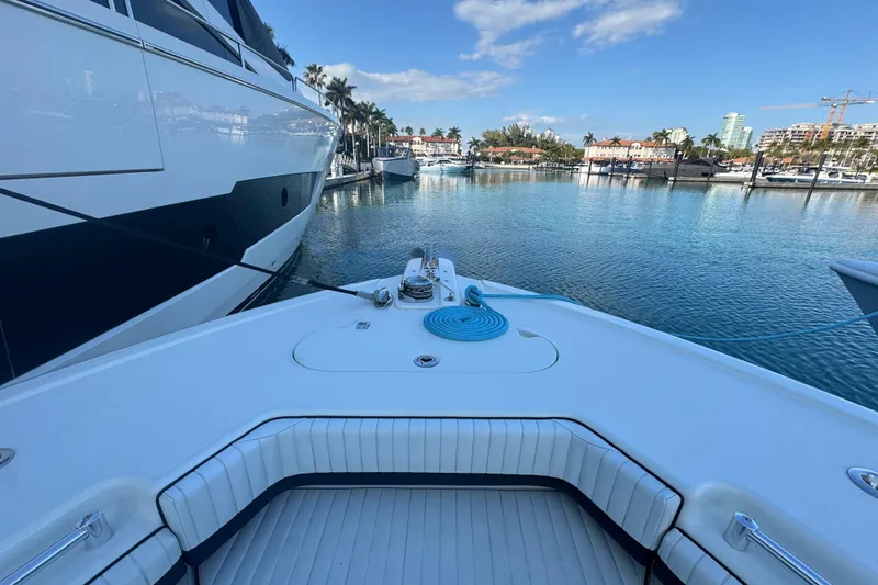 Slide: The Image of 2014 Yellowfin 39 Offshore boat docked in a scenic marina with clear skies. - 20