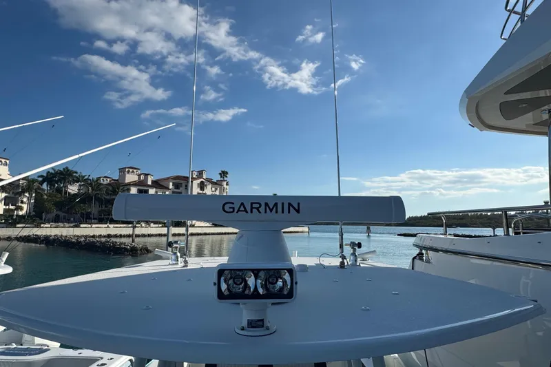 Slide: The Image of 2014 Yellowfin 39 Offshore boat with Garmin radar, docked near luxury waterfront homes. - 22