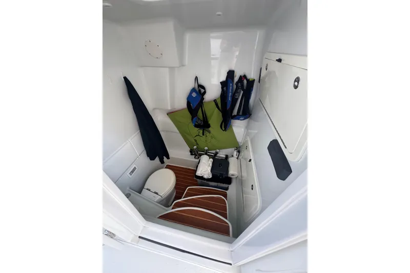 Slide: The Image of 2014 Yellowfin 39 Offshore boat interior with toilet, life jackets, and storage space. - 23