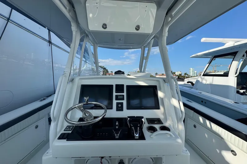 Slide: The Image of 2014 Yellowfin 39 Offshore boat cockpit with modern controls and dual screens. - 4