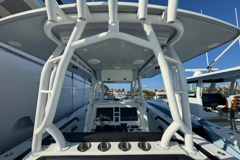 Slide: The Image of 2014 Yellowfin 39 Offshore boat cockpit with modern controls and sturdy T-top. - 5