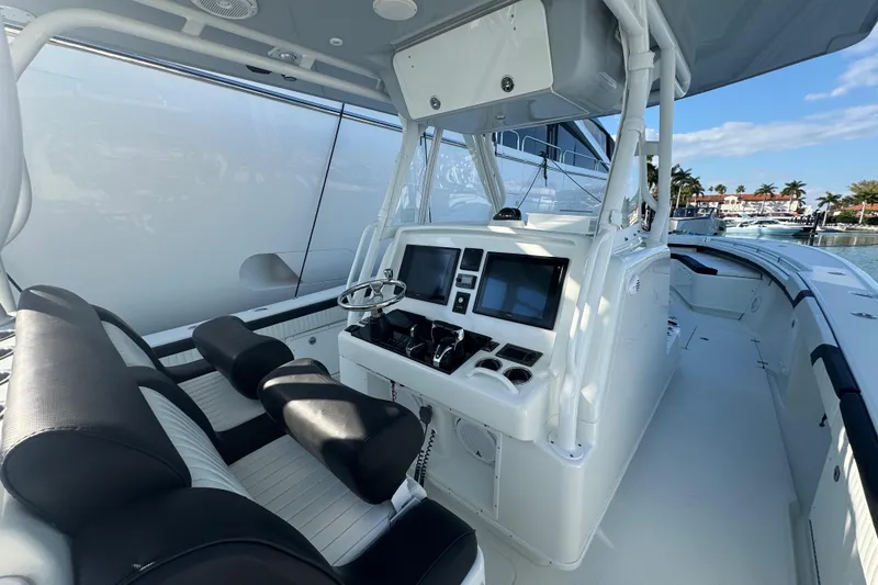 Slide: The Image of 2014 Yellowfin 39 Offshore boat interior with dual screens and seating. - 6