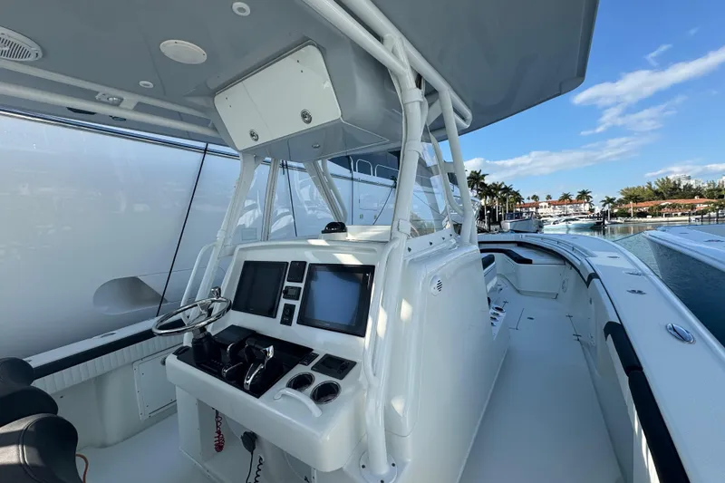 Slide: The Image of 2014 Yellowfin 39 Offshore boat cockpit with modern navigation equipment and steering wheel. - 7