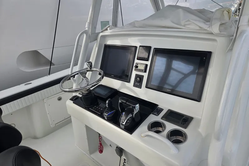 Slide: The Image of Helm of 2014 Yellowfin 39 Offshore boat with dual screens and controls. - 8