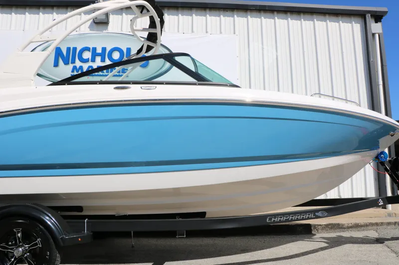 Slide: The Image of 2026 Chaparral 23 SSi boat in front of a building. - 8