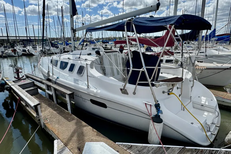 Slide: The Image of 2001 Hunter 320 sailboat docked at marina under blue sky. - 1