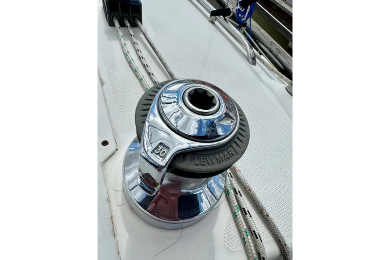 Slide: The Image of Chrome winch on 2001 Hunter 320 sailboat deck with ropes. - 10