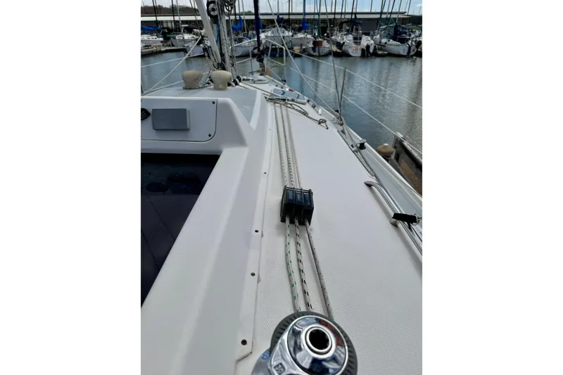 Slide: The Image of 2001 Hunter 320 sailboat deck with rigging, docked in marina. - 11