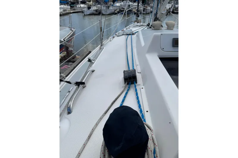 Slide: The Image of 2001 Hunter 320 sailboat deck with ropes and marina view. - 13