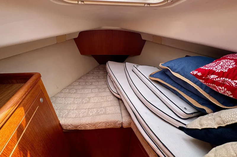 Slide: The Image of Cozy cabin interior of 2001 Hunter 320 sailboat with cushions and pillows. - 20