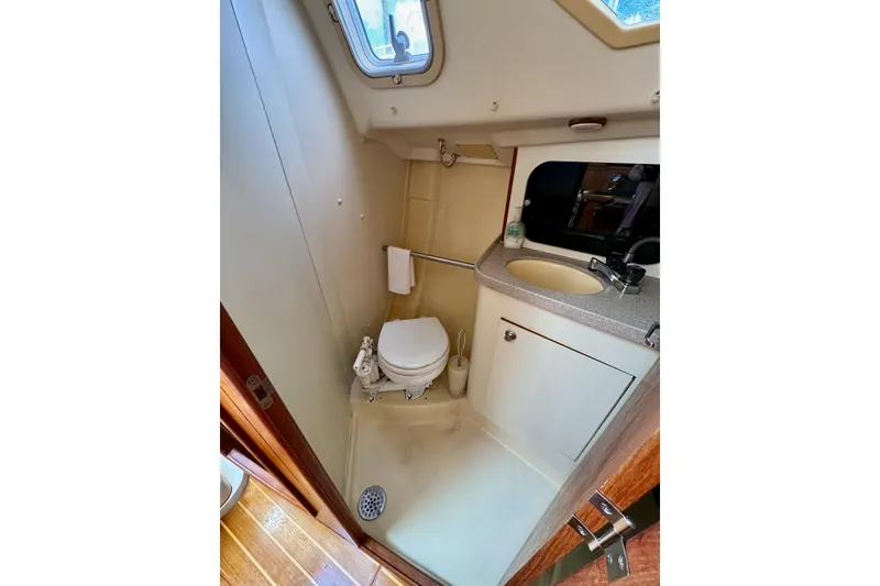 Slide: The Image of Compact bathroom in 2001 Hunter 320 sailboat with toilet, sink, and window. - 22