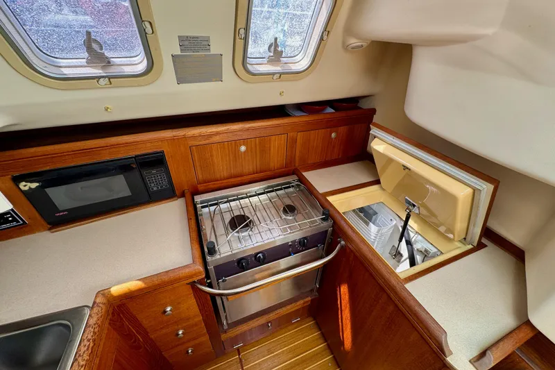 Slide: The Image of Interior of 2001 Hunter 320 sailboat galley with stove, microwave, and storage. - 23