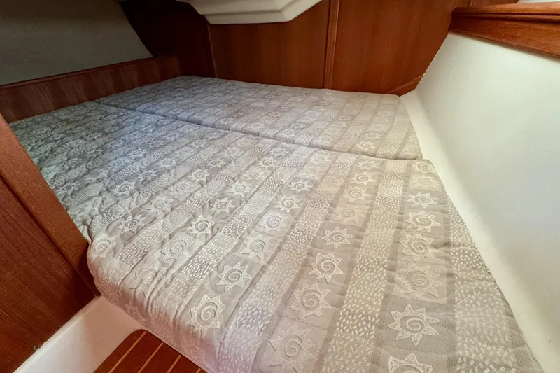 Slide: The Image of Interior cabin of 2001 Hunter 320 sailboat with patterned bedding. - 26