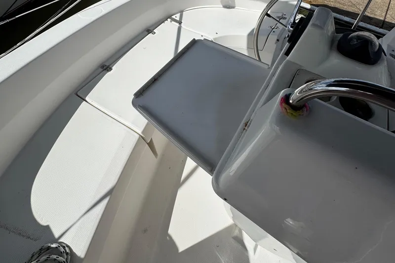 Slide: The Image of Interior view of a 2001 Hunter 320 sailboat cockpit with steering wheel. - 28