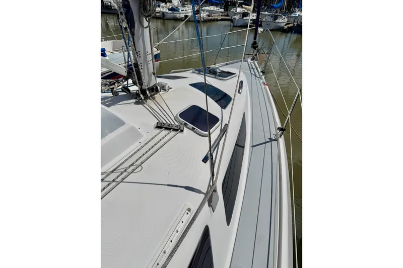 Slide: The Image of 2001 Hunter 320 sailboat deck view in marina, showcasing rigging and hatches. - 29