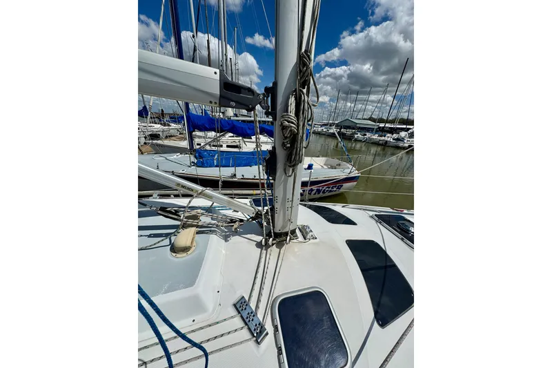 Slide: The Image of Sailboat deck view, Hunter 320, 2001 model, docked in marina under cloudy sky. - 30