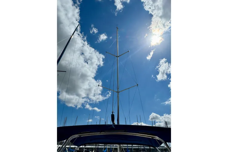 Slide: The Image of Sailboat mast against blue sky with clouds, Hunter 320, 2001 model. - 7