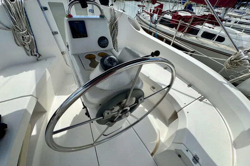 Slide: The Image of Cockpit of 2001 Hunter 320 sailboat with steering wheel and navigation instruments. - 8