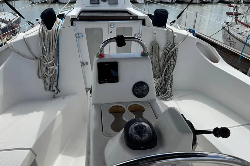 Slide: The Image of Cockpit of a 2001 Hunter 320 sailboat with navigation instruments and ropes. - 9