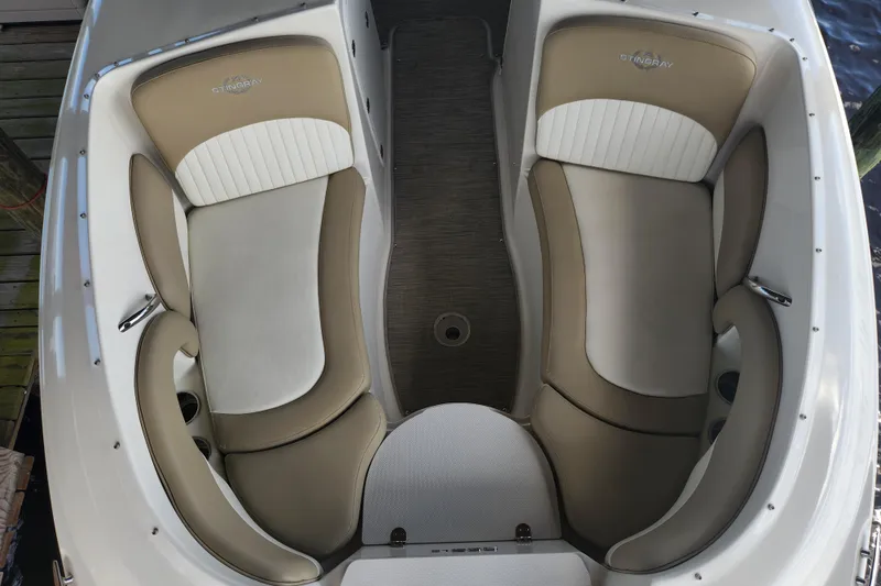 Slide: The Image of 2018 Stingray 235 LR boat interior with beige and white seating, top view. - 16
