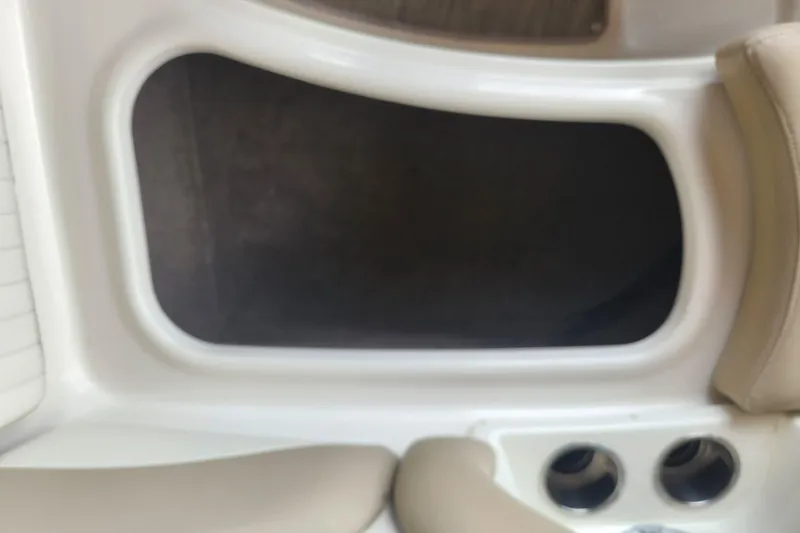 Slide: The Image of Interior view of a 2018 Stingray 235 LR boat, featuring seating and storage compartment. - 22