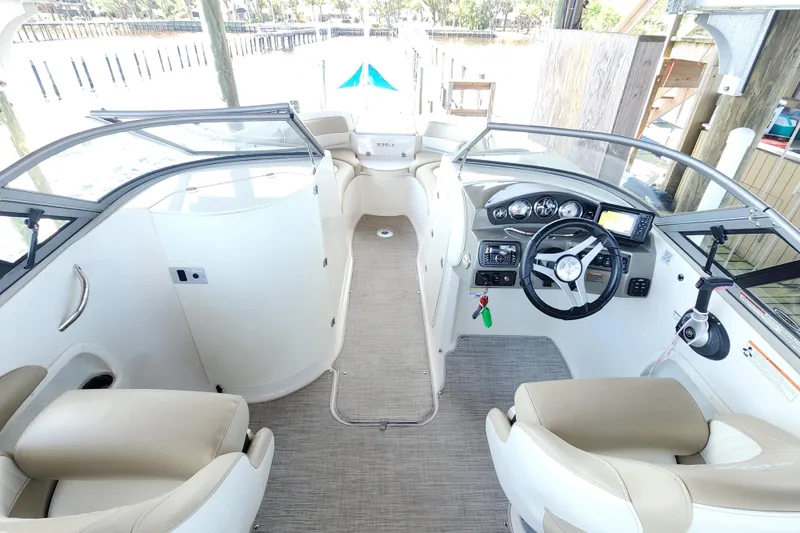 Slide: The Image of 2018 Stingray 235 LR boat interior with steering wheel and dashboard controls. - 28