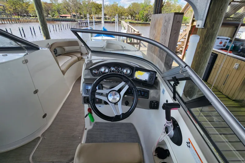 Slide: The Image of 2018 Stingray 235 LR boat interior with steering wheel and navigation system. - 31
