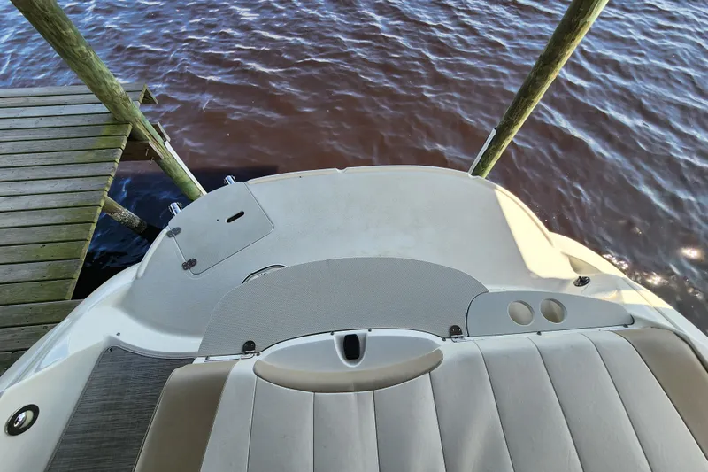 Slide: The Image of 2018 Stingray 235 LR boat docked on calm water, viewed from above. - 53