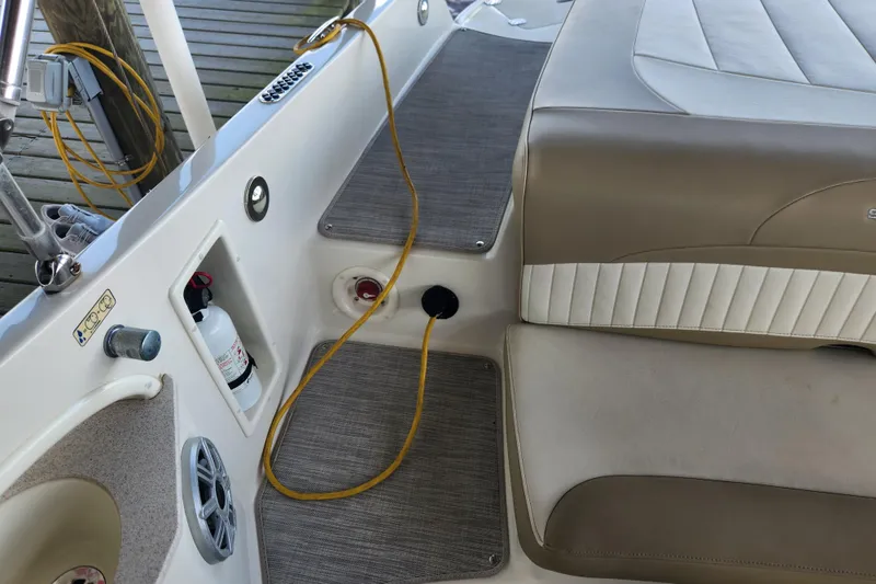 Slide: The Image of 2018 Stingray 235 LR boat interior with seating, fire extinguisher, and speaker. - 55
