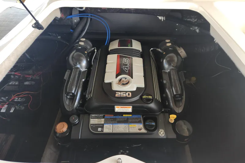 Slide: The Image of 2018 Stingray 235 LR boat engine compartment with Mercury 4.5L 250 HP engine. - 61