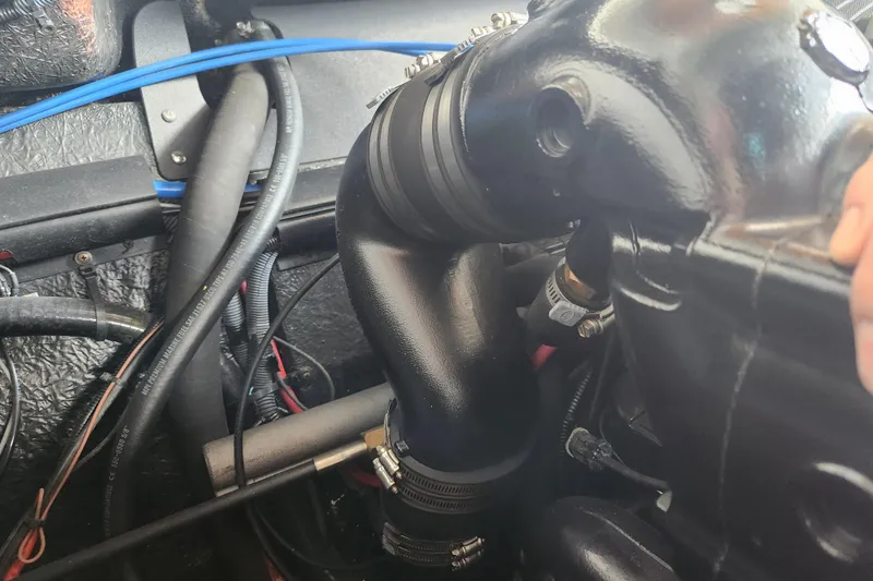 Slide: The Image of Engine compartment of a 2018 Stingray 235 LR boat, showcasing hoses and components. - 63