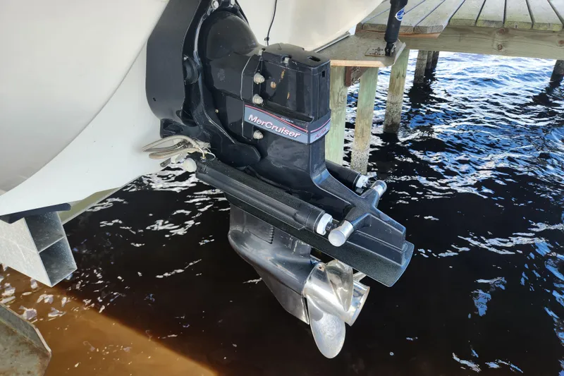 Slide: The Image of 2018 Stingray 235 LR boat with MerCruiser outboard motor near wooden dock. - 68