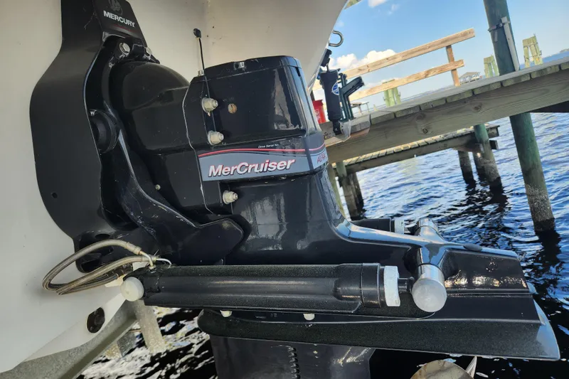 Slide: The Image of 2018 Stingray 235 LR boat with MerCruiser engine near a wooden dock. - 70