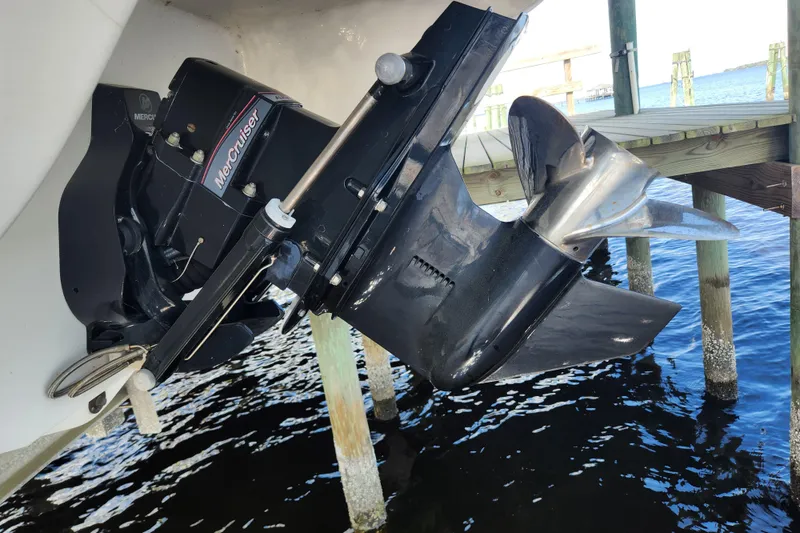 Slide: The Image of 2018 Stingray 235 LR boat with MerCruiser outdrive and propeller near dock. - 71