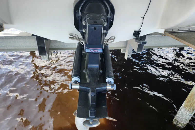 Slide: The Image of 2018 Stingray 235 LR boat outdrive and propeller above water. - 73