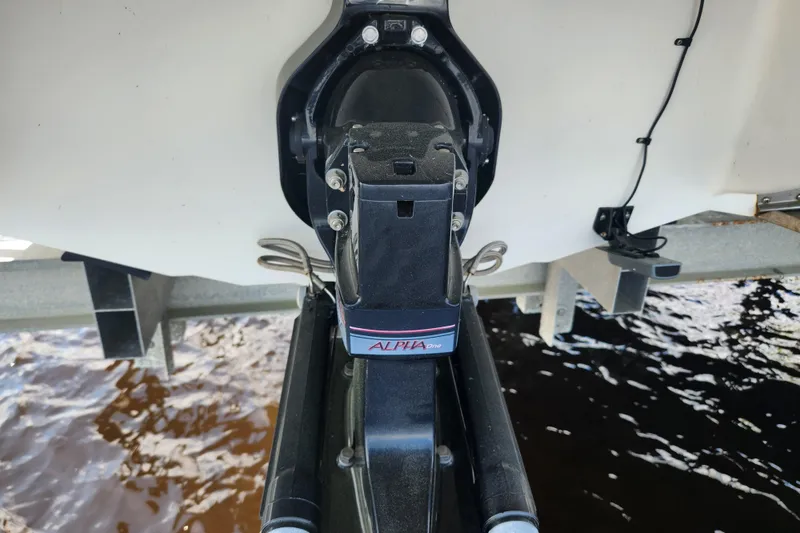 Slide: The Image of 2018 Stingray 235 LR boat with Alpha One outdrive, docked by water. - 74