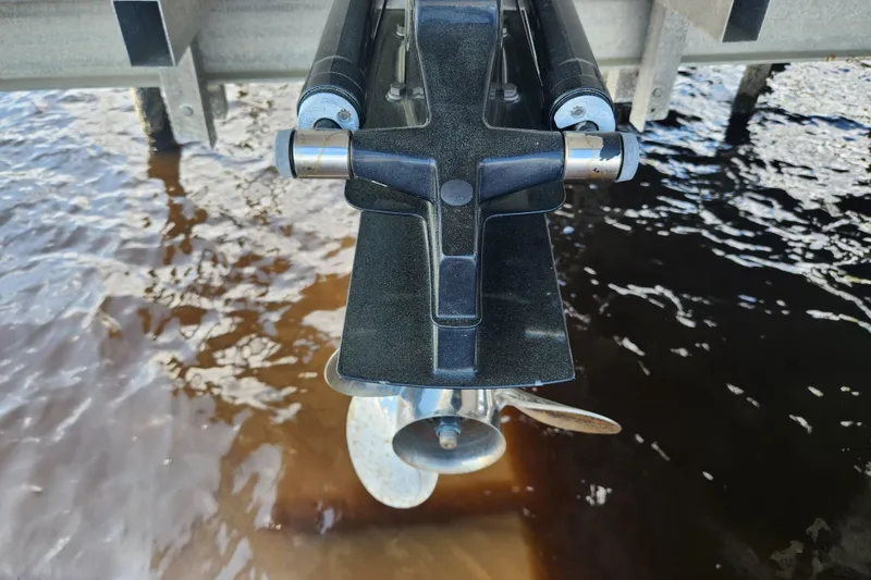 Slide: The Image of 2018 Stingray 235 LR boat propeller and trim tab above water. - 75