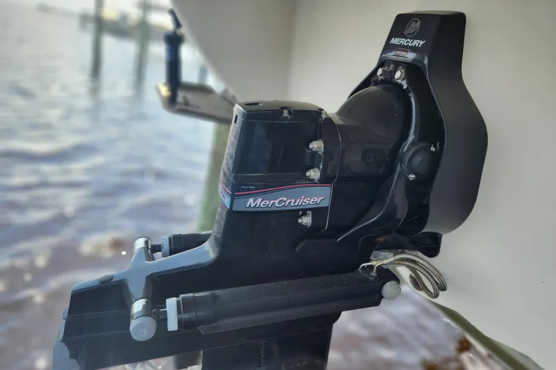 Slide: The Image of 2018 Stingray 235 LR boat with MerCruiser engine, docked by the water. - 77