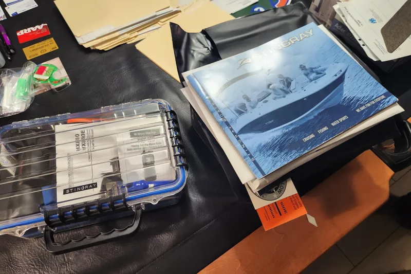 Slide: The Image of Stingray 235 LR 2018 manual and accessories on a desk. - 86