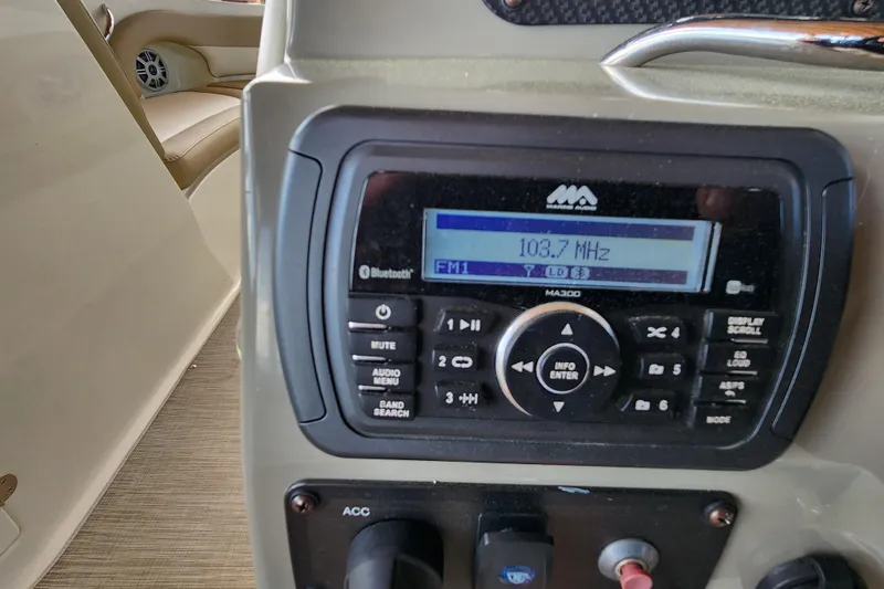 Slide: The Image of Marine audio system in a 2018 Stingray 235 LR boat, tuned to 103.7 MHz. - 87